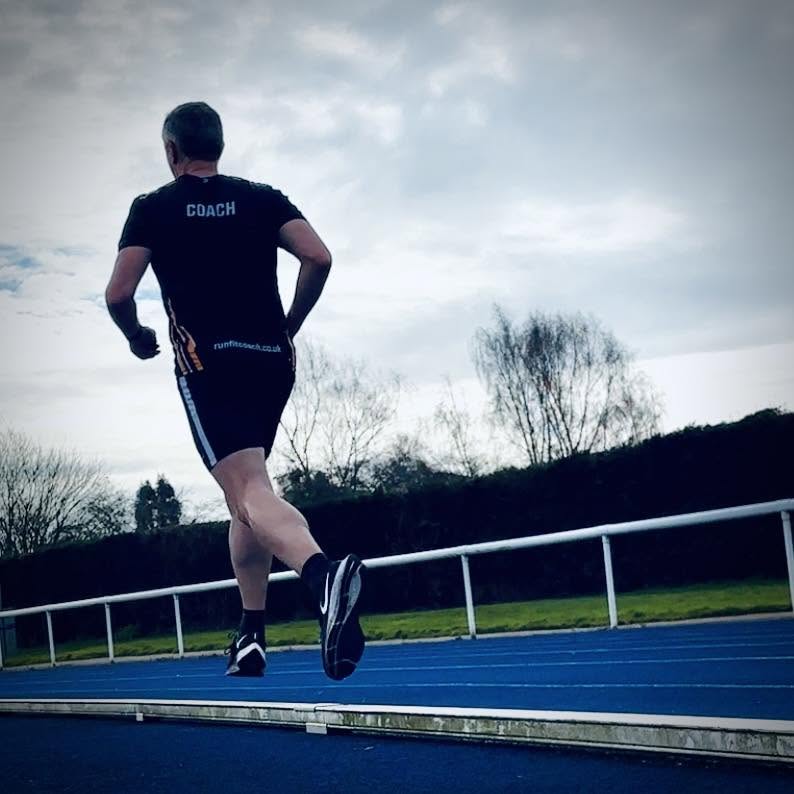 Runner training on an athletics track